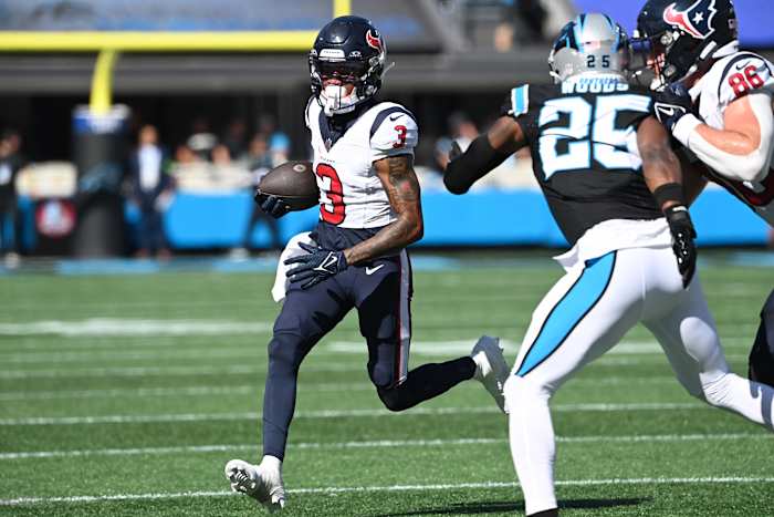 Houston Texans wide receiver Tank Dell (3) runs as Carolina Panthers safety Xavier Woods (25) defends in the first quarter at Bank of America Stadium.